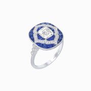 Platinum Cushion Cut Diamond Ring with Calibre-Cut Sapphire Halo