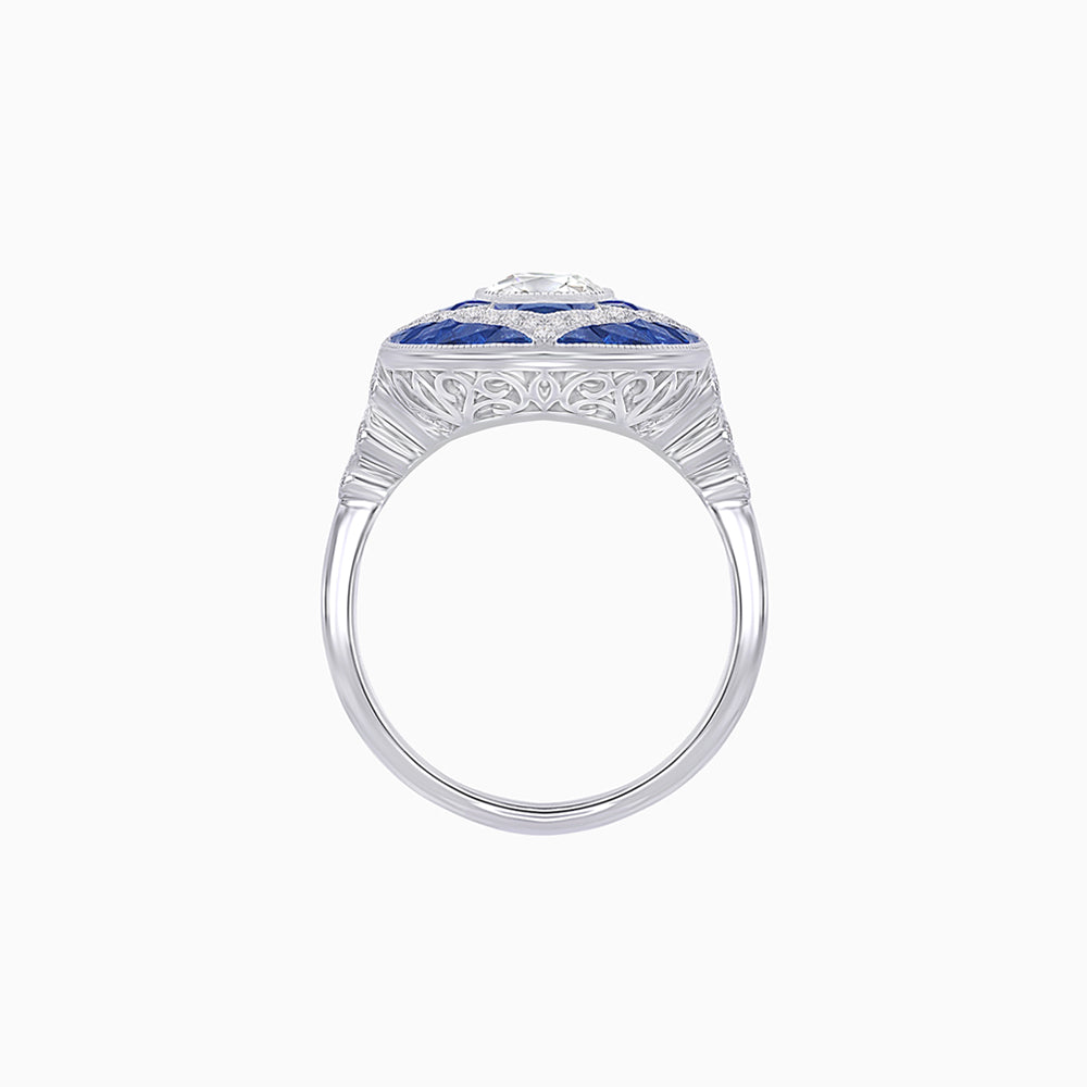 Platinum Cushion Cut Diamond Ring with Calibre-Cut Sapphire Halo